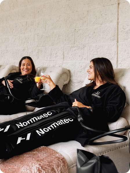 - The Renaissance Day Spa & Alternative Wellness, Fayetteville NC Two women sit in reclining chairs, wearing Normatec leg compression sleeves, smiling and clinking glasses of orange beverage as they enjoy a relaxing body toning and contouring treatment together. - The Renaissance Day Spa & Alternative Wellness, Fayetteville NC