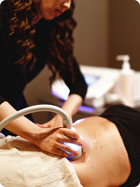 - The Renaissance Day Spa & Alternative Wellness, Fayetteville NC A person receives a body toning and contouring treatment with a handheld device applied to their stomach by a professional, offering benefits similar to holistic alternative therapies. - The Renaissance Day Spa & Alternative Wellness, Fayetteville NC