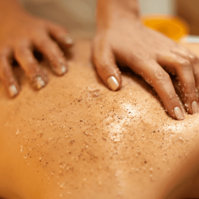 - The Renaissance Day Spa & Alternative Wellness, Fayetteville NC Hands exfoliating a person's back with a grainy scrub in a spa or wellness setting. - The Renaissance Day Spa & Alternative Wellness, Fayetteville NC