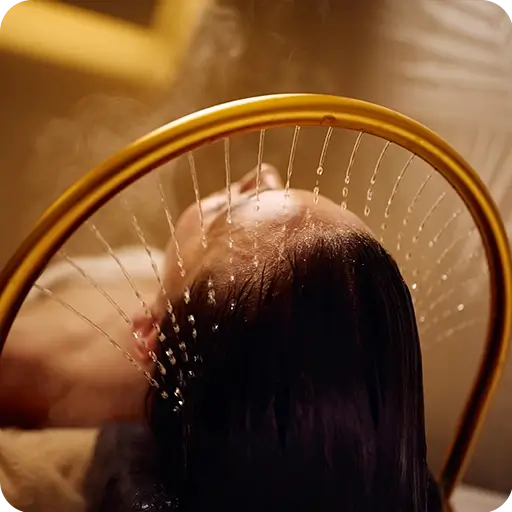 - The Renaissance Day Spa & Alternative Wellness, Fayetteville NC Person lying down with their head under a curved shower spraying water evenly over their scalp. - The Renaissance Day Spa & Alternative Wellness, Fayetteville NC