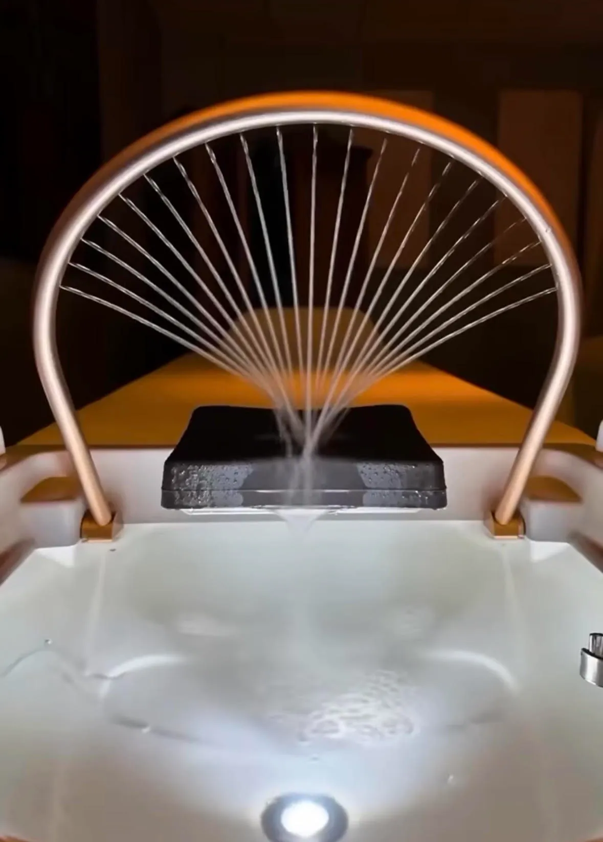 - The Renaissance Day Spa & Alternative Wellness, Fayetteville NC A fountain featuring a metal arch that sprays a fan of water into a basin. - The Renaissance Day Spa & Alternative Wellness, Fayetteville NC